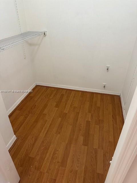 11479 NW 60th Ter Unit 372, Doral, FL 33178 - walk in closet with light wood finished floors