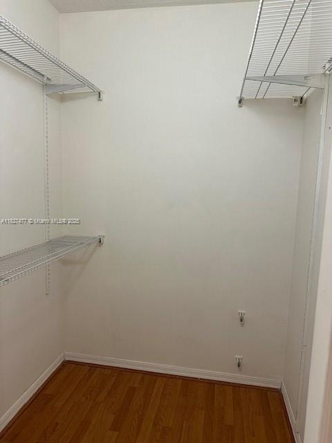 11479 NW 60th Ter Unit 372, Doral, FL 33178 - walk in closet featuring wood finished floors