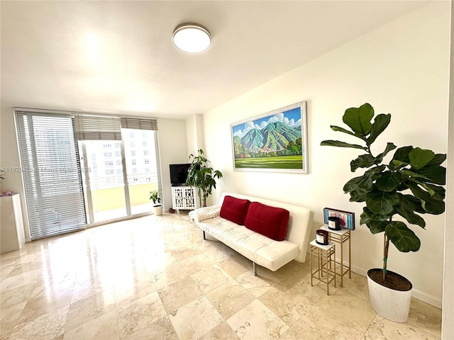 808 Brickell Key Dr Unit 1103, Miami, FL 33131 - sitting room with baseboards and stone finish flooring