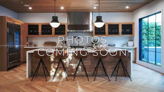 1750 N Bayshore Dr Unit 1415, Miami, FL 33132 - kitchen with built in refrigerator, wall chimney range hood, light countertops, a center island with sink, and recessed lighting
