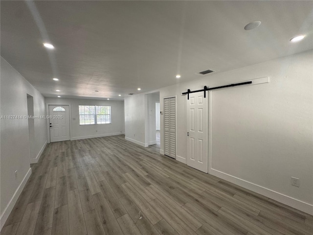 1657 SW 44th Ave, Fort Lauderdale, FL 33317 - spare room featuring a barn door, wood finished floors, and recessed lighting