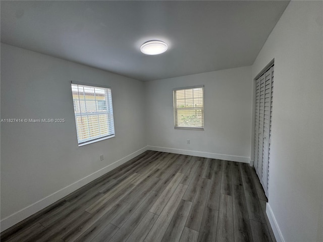 1657 SW 44th Ave, Fort Lauderdale, FL 33317 - unfurnished bedroom with multiple windows and dark wood-type flooring