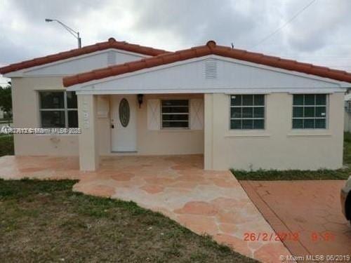 1498 NE 180th St, North Miami Beach, FL 33162 - view of front facade with stucco siding