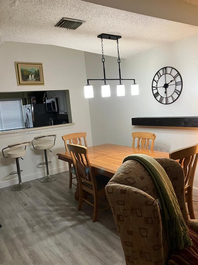 2326 SW 82nd Ter, North Lauderdale, FL 33068 - dining area featuring wood finished floors and a textured ceiling