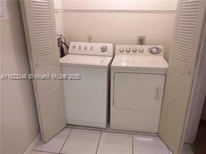 2326 SW 82nd Ter, North Lauderdale, FL 33068 - washroom with washer and clothes dryer and light tile patterned floors