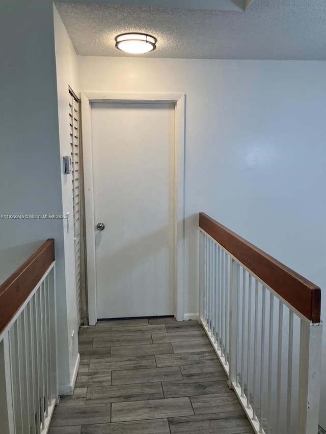 2326 SW 82nd Ter, North Lauderdale, FL 33068 - corridor with a textured ceiling and wood finished floors