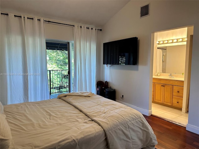 2326 SW 82nd Ter, North Lauderdale, FL 33068 - bedroom with vaulted ceiling, access to outside, wood finished floors, and connected bathroom