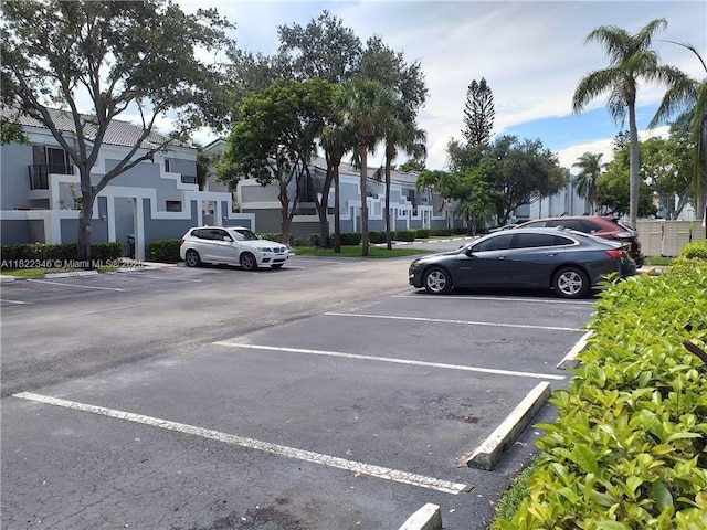 2326 SW 82nd Ter, North Lauderdale, FL 33068 - uncovered parking lot featuring a residential view