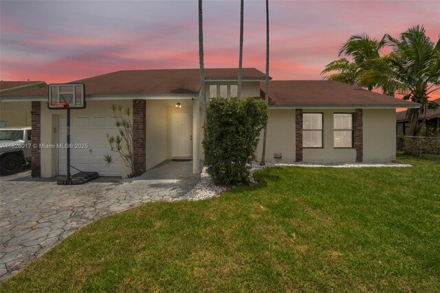 4947 NW 91st Ter, Sunrise, FL 33351 - view of front of home with stucco siding, a garage, and brick siding