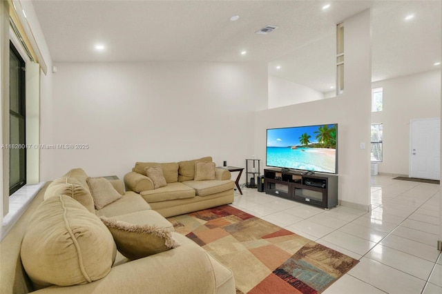 4947 NW 91st Ter, Sunrise, FL 33351 - living room featuring high vaulted ceiling, light tile patterned flooring, and recessed lighting