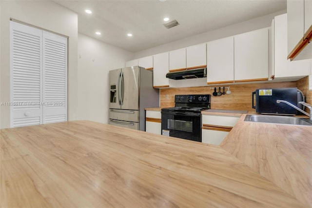4947 NW 91st Ter, Sunrise, FL 33351 - kitchen featuring black electric range oven, under cabinet range hood, stainless steel fridge, decorative backsplash, and recessed lighting