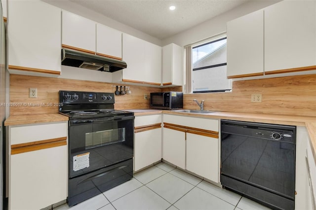 4947 NW 91st Ter, Sunrise, FL 33351 - kitchen with black appliances, under cabinet range hood, light countertops, backsplash, and white cabinetry