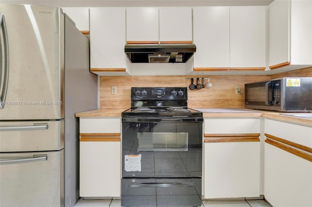 4947 NW 91st Ter, Sunrise, FL 33351 - kitchen with freestanding refrigerator, black range with electric cooktop, under cabinet range hood, light countertops, and decorative backsplash