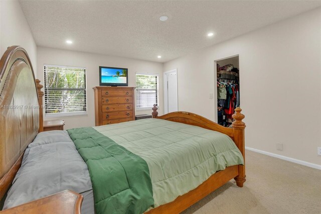 4947 NW 91st Ter, Sunrise, FL 33351 - bedroom featuring carpet, recessed lighting, a textured ceiling, and a walk in closet
