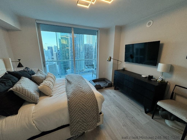 500 Brickell Ave Unit 3803, Miami, FL 33131 - bedroom with light wood finished floors, access to exterior, and a wall of windows