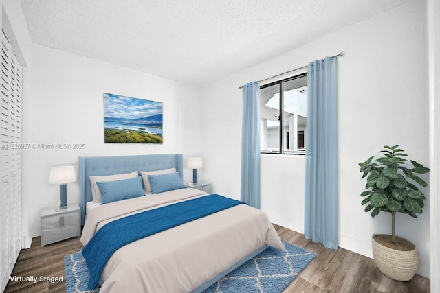 8365 SW 152nd Ave Unit C-201, Miami, FL 33193 - bedroom featuring wood finished floors and a textured ceiling