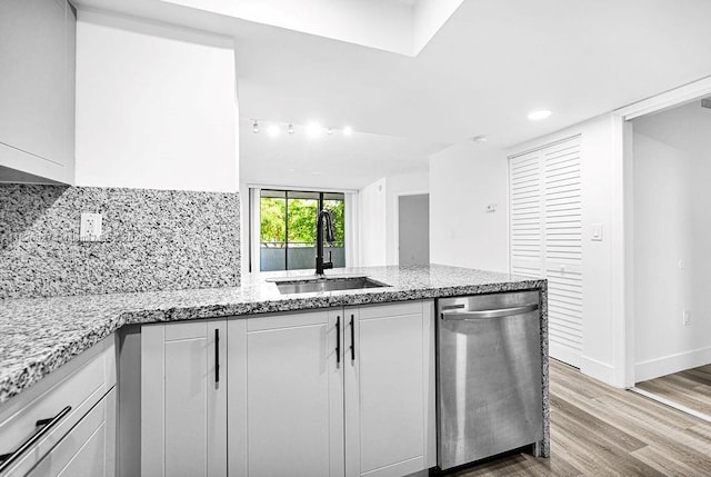 8365 SW 152nd Ave Unit C-201, Miami, FL 33193 - kitchen with dishwasher, a peninsula, white cabinets, light wood-type flooring, and light stone countertops