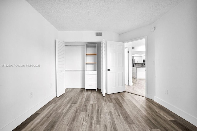 8365 SW 152nd Ave Unit C-201, Miami, FL 33193 - unfurnished bedroom with wood finished floors, a textured ceiling, and a closet