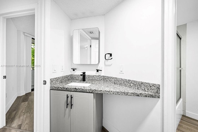 8365 SW 152nd Ave Unit C-201, Miami, FL 33193 - bathroom with vanity, wood finished floors, and a textured ceiling