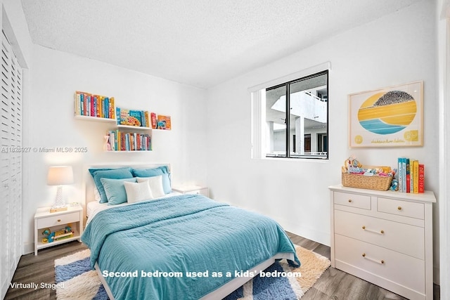 8365 SW 152nd Ave Unit C-201, Miami, FL 33193 - bedroom featuring wood finished floors and a textured ceiling
