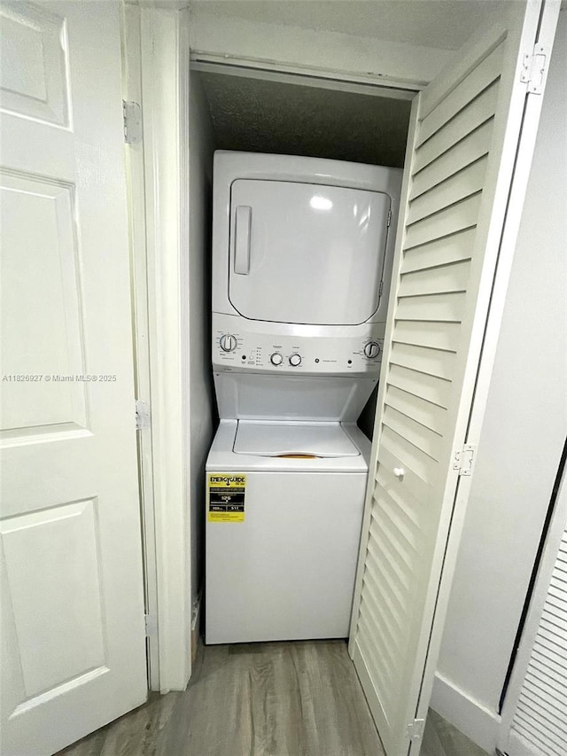 8365 SW 152nd Ave Unit C-201, Miami, FL 33193 - laundry room featuring stacked washer / drying machine and wood finished floors