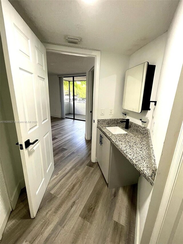8365 SW 152nd Ave Unit C-201, Miami, FL 33193 - bathroom with wood finished floors, vanity, and a textured ceiling