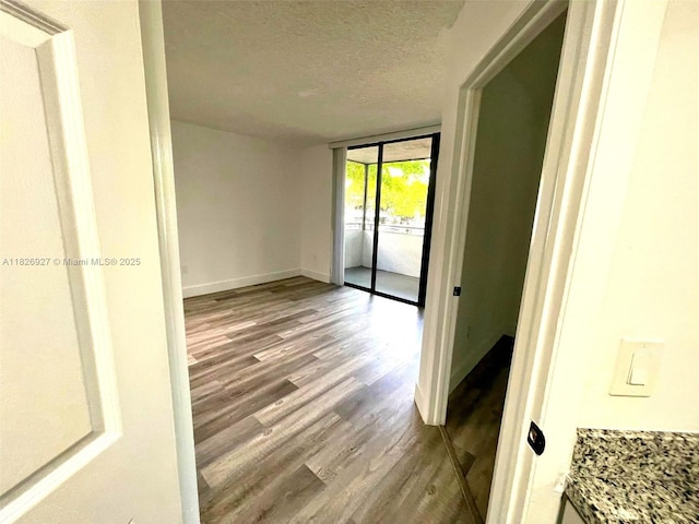 8365 SW 152nd Ave Unit C-201, Miami, FL 33193 - spare room featuring dark wood-style flooring and a textured ceiling