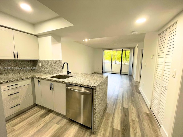 8365 SW 152nd Ave Unit C-201, Miami, FL 33193 - kitchen with stainless steel dishwasher, light wood-style flooring, a peninsula, open floor plan, and light stone counters