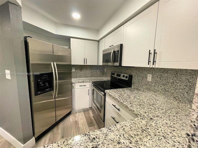 8365 SW 152nd Ave Unit C-201, Miami, FL 33193 - kitchen with appliances with stainless steel finishes, light wood-style floors, light stone counters, and white cabinets