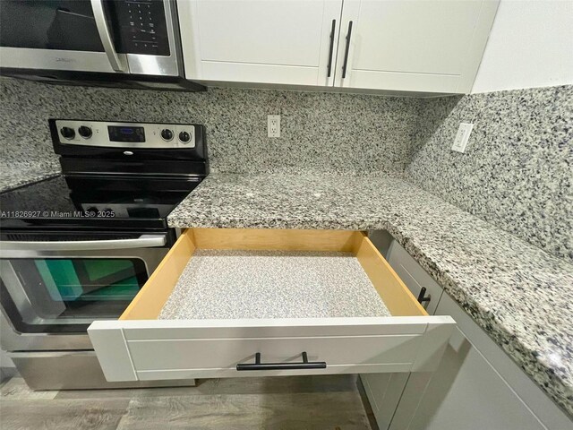 8365 SW 152nd Ave Unit C-201, Miami, FL 33193 - kitchen with appliances with stainless steel finishes, white cabinetry, tasteful backsplash, and light countertops