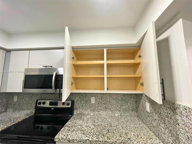 8365 SW 152nd Ave Unit C-201, Miami, FL 33193 - kitchen with appliances with stainless steel finishes, white cabinetry, backsplash, and light stone countertops