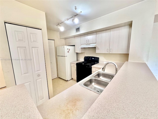 11185 SW 6th St Unit 303, Pembroke Pines, FL 33025 - kitchen with electric range, freestanding refrigerator, under cabinet range hood, light countertops, and track lighting