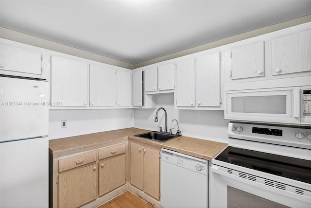 16851 NE 23rd Ave Unit A619, North Miami Beach, FL 33160 - kitchen with white appliances, light wood-type flooring, and tile counters