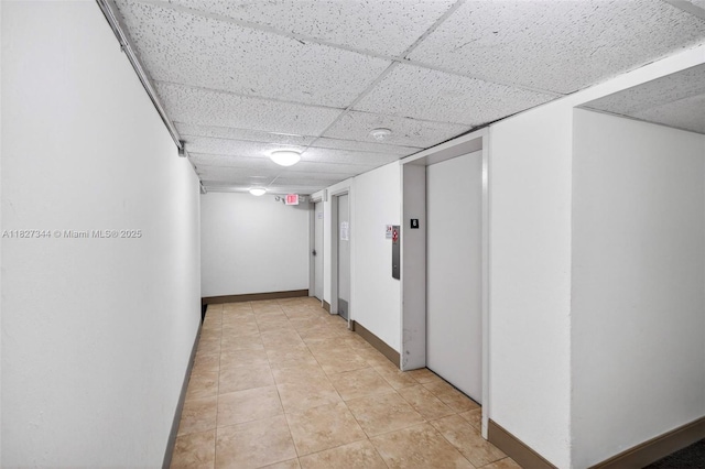 16851 NE 23rd Ave Unit A619, North Miami Beach, FL 33160 - hall with a drop ceiling, elevator, and light tile patterned flooring