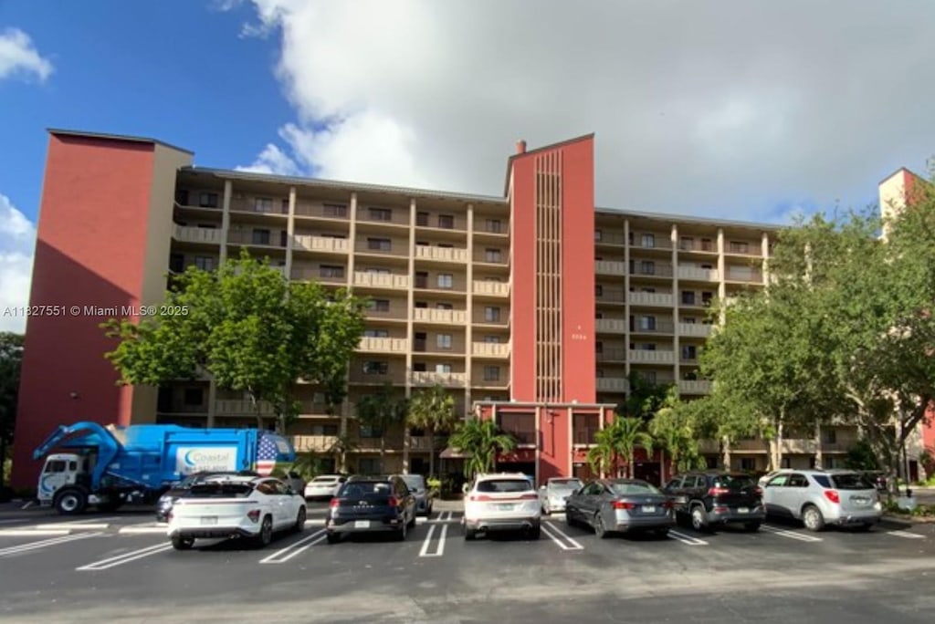 2206 S Cypress Bend Dr Unit 801, Pompano Beach, FL 33069 - view of apartment building / complex featuring uncovered parking