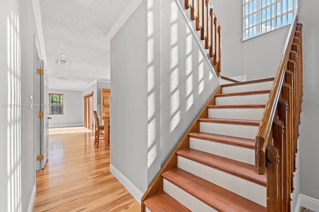 20155 E Oakmont Cir, Hialeah, FL 33015 - staircase featuring wood finished floors, a textured ceiling, and ornamental molding