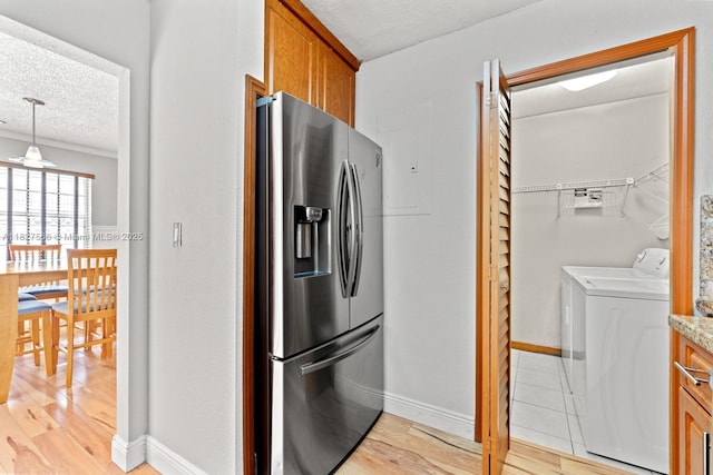 20155 E Oakmont Cir, Hialeah, FL 33015 - kitchen with stainless steel fridge, brown cabinets, light wood-style floors, a textured ceiling, and washer and dryer