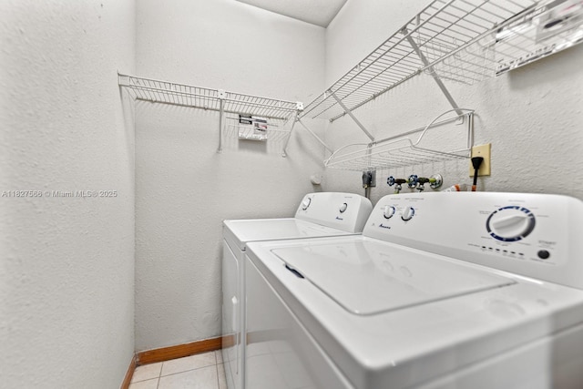 20155 E Oakmont Cir, Hialeah, FL 33015 - laundry area featuring washing machine and dryer, a textured wall, and light tile patterned flooring