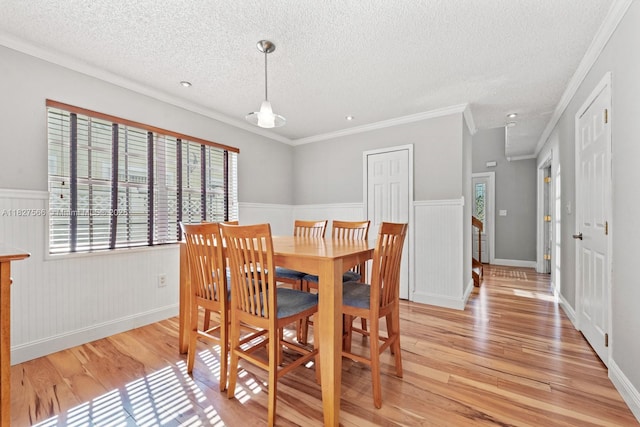 20155 E Oakmont Cir, Hialeah, FL 33015 - dining area with light wood finished floors, a textured ceiling, wainscoting, and ornamental molding