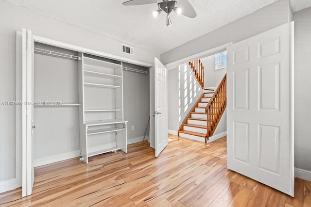 20155 E Oakmont Cir, Hialeah, FL 33015 - unfurnished bedroom featuring light wood finished floors, a textured ceiling, a closet, and a ceiling fan