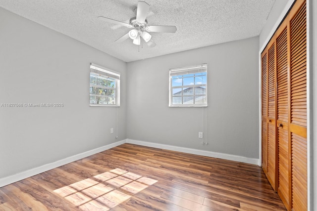 20155 E Oakmont Cir, Hialeah, FL 33015 - unfurnished bedroom featuring a closet, wood finished floors, a textured ceiling, and ceiling fan