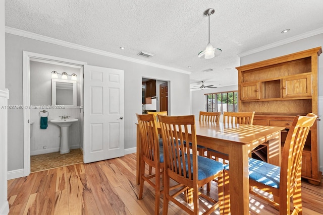 20155 E Oakmont Cir, Hialeah, FL 33015 - dining area with light wood-style floors, a textured ceiling, ornamental molding, and a ceiling fan