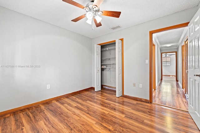 20155 E Oakmont Cir, Hialeah, FL 33015 - unfurnished bedroom featuring wood finished floors, a ceiling fan, and a closet