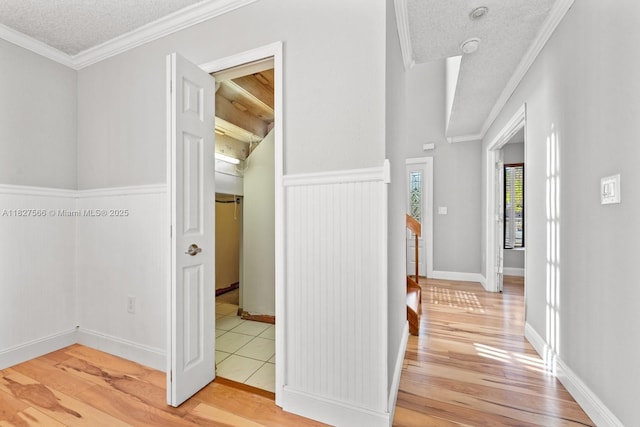 20155 E Oakmont Cir, Hialeah, FL 33015 - corridor featuring light wood-type flooring, crown molding, a textured ceiling, and a wainscoted wall