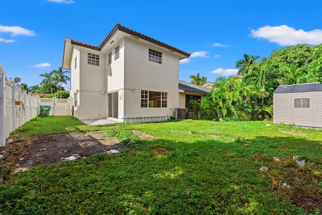20155 E Oakmont Cir, Hialeah, FL 33015 - rear view of property with a storage unit, a fenced backyard, stucco siding, and a tile roof