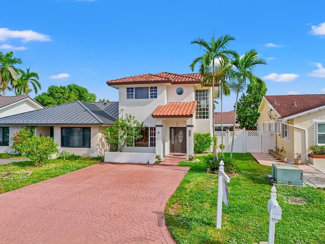 20155 E Oakmont Cir, Hialeah, FL 33015 - mediterranean / spanish-style house with stucco siding, a gate, a tiled roof, and driveway