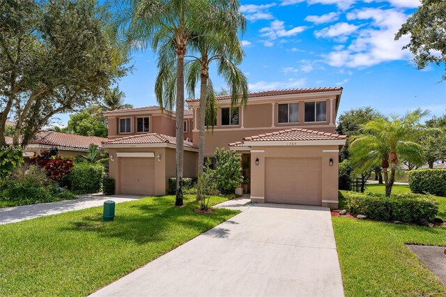 1784 SW 110th Ter, Davie, FL 33324 - mediterranean / spanish-style home with stucco siding, a tile roof, driveway, a front lawn, and a garage