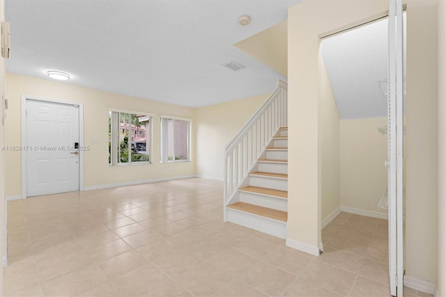 1784 SW 110th Ter, Davie, FL 33324 - entryway featuring stairway, light tile patterned floors, and a textured ceiling