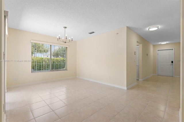1784 SW 110th Ter, Davie, FL 33324 - unfurnished room with a chandelier, light tile patterned flooring, and a textured ceiling