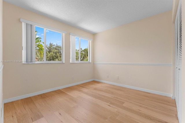 1784 SW 110th Ter, Davie, FL 33324 - empty room with light wood-type flooring and a textured ceiling